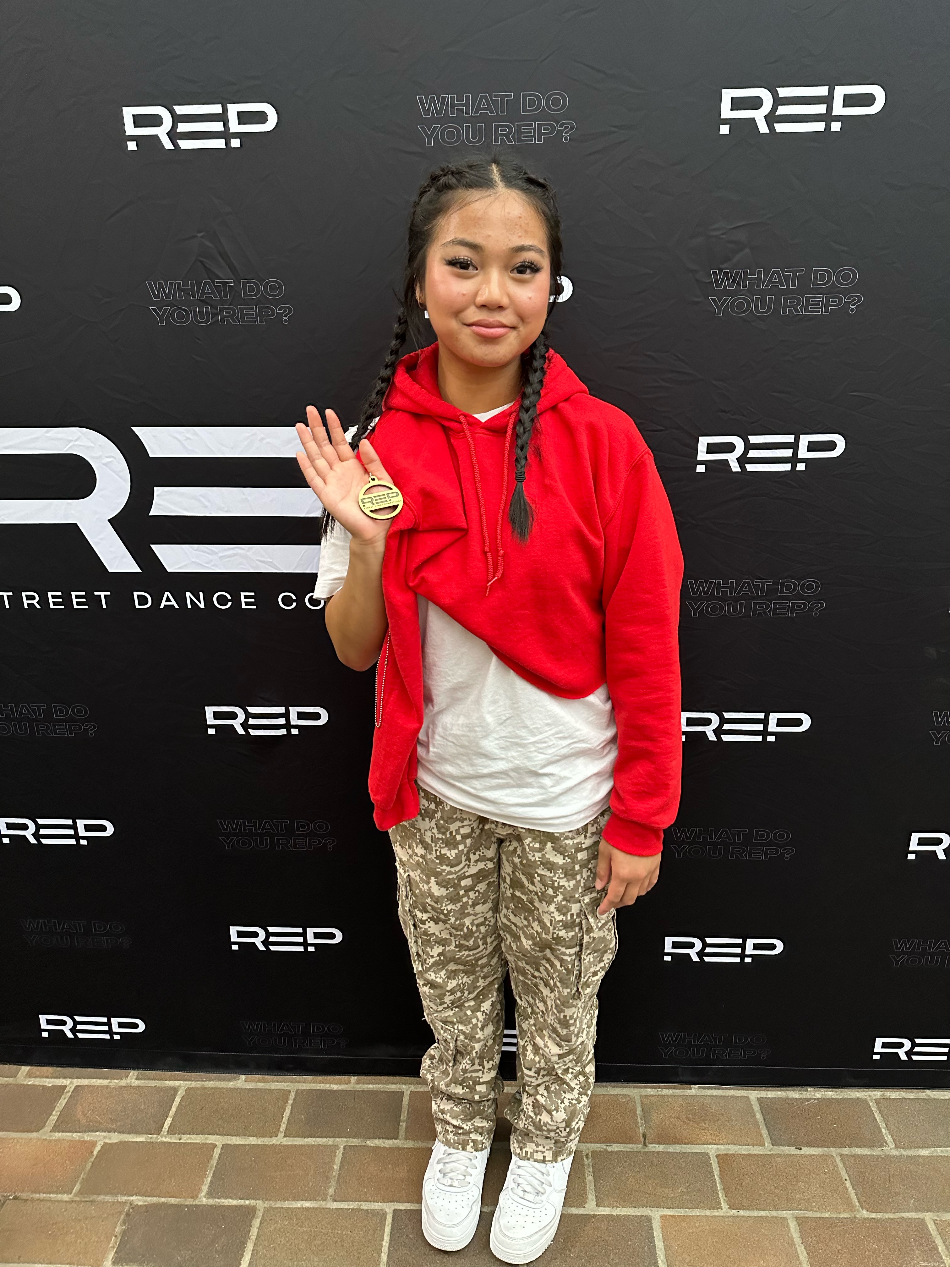 Emma showing her medal at a street dance competition
